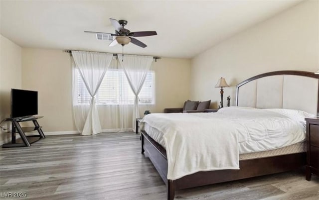 bedroom with hardwood / wood-style flooring and ceiling fan