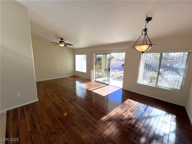 unfurnished living room with ceiling fan and dark wood-type flooring