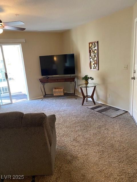 living room featuring ceiling fan and carpet flooring