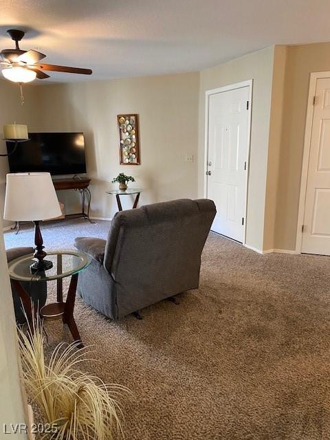 living room featuring carpet flooring and ceiling fan