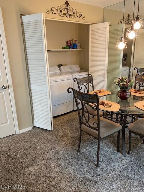 dining room featuring washer and dryer and baseboards