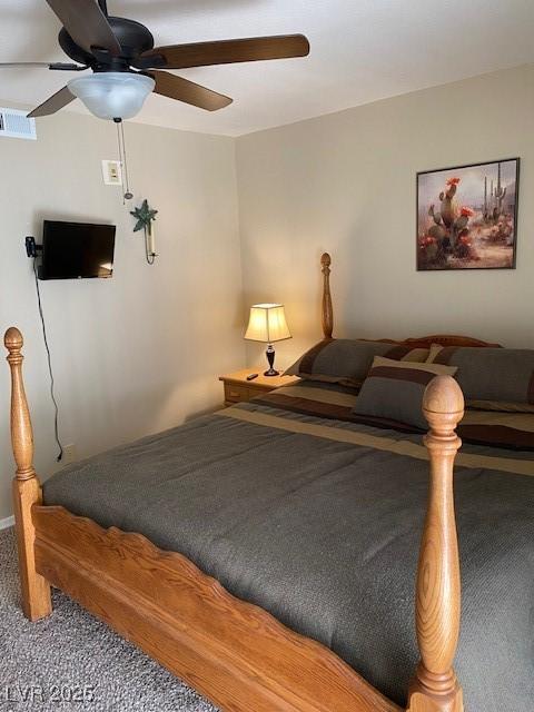 carpeted bedroom with visible vents and ceiling fan