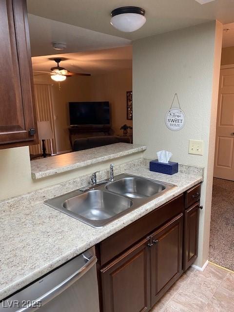 kitchen with ceiling fan, stainless steel dishwasher, sink, and dark brown cabinets