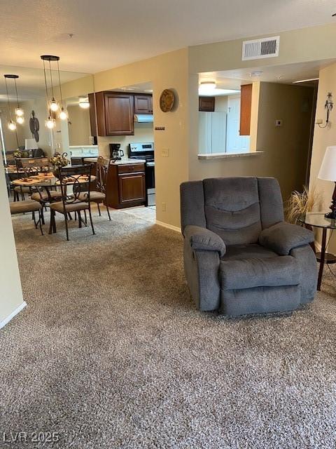 living area featuring baseboards and visible vents