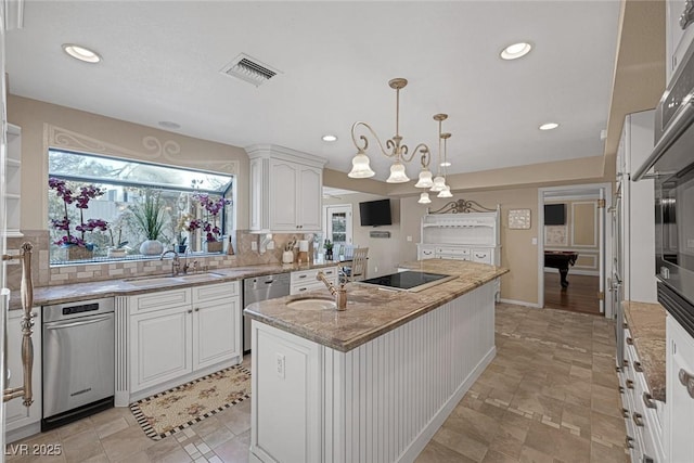 kitchen with a center island, white cabinetry, decorative light fixtures, stainless steel dishwasher, and tasteful backsplash