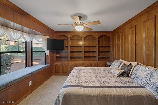 bedroom with wood walls, ceiling fan, and light carpet