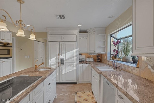 kitchen with stainless steel oven, decorative light fixtures, black electric cooktop, white cabinetry, and white dishwasher