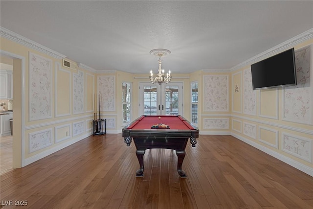 playroom with french doors, pool table, hardwood / wood-style floors, and a chandelier