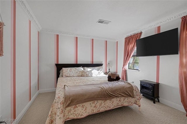 bedroom with ornamental molding, light carpet, and a wood stove