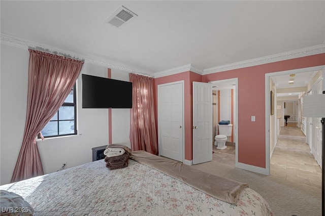 carpeted bedroom featuring ornamental molding and connected bathroom