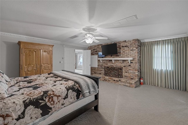 carpeted bedroom with ceiling fan, crown molding, a fireplace, and a textured ceiling