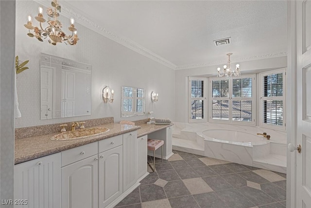 bathroom featuring a relaxing tiled tub, a chandelier, crown molding, vanity, and a textured ceiling