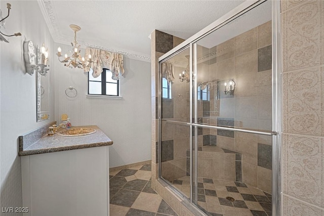 bathroom featuring a chandelier, walk in shower, crown molding, tile patterned floors, and vanity