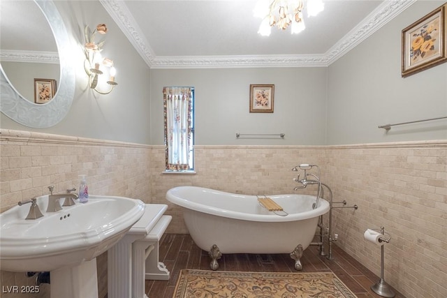 bathroom with tile walls, crown molding, and a tub to relax in