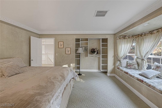 bedroom with ornamental molding and carpet floors