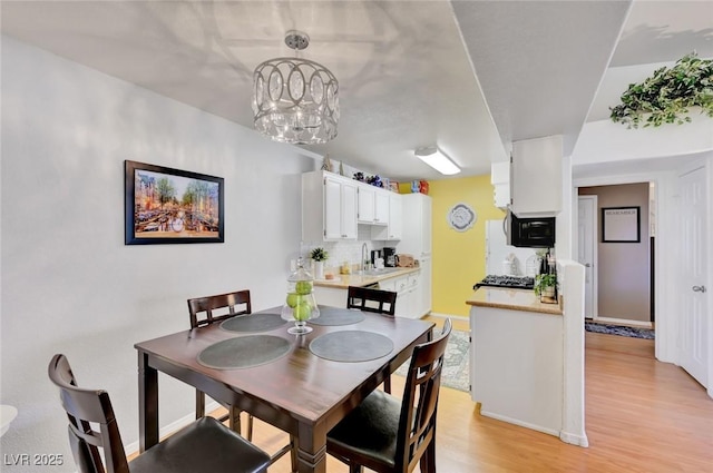 dining space featuring sink and light hardwood / wood-style floors