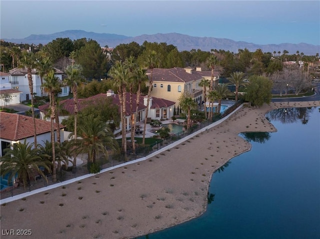 birds eye view of property with a water and mountain view