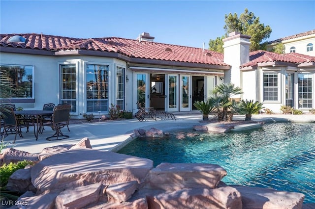 back of property with french doors and a patio