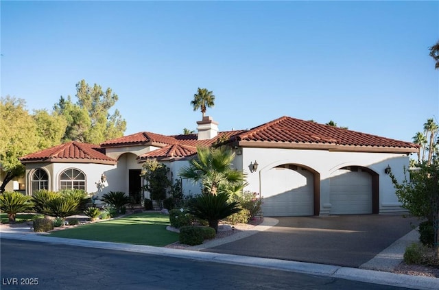 mediterranean / spanish house with a garage