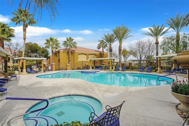 view of pool with a community hot tub and a patio