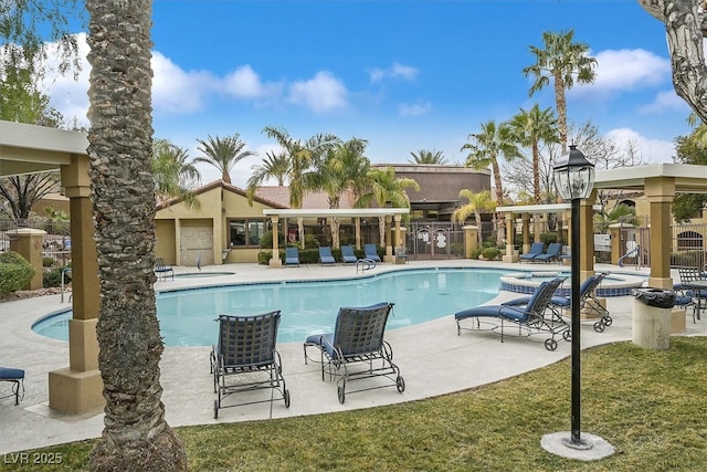 view of swimming pool featuring a lawn and a patio area