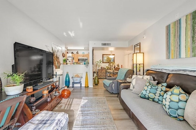 living room with light hardwood / wood-style flooring