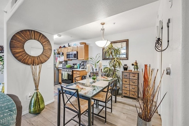 dining space featuring light hardwood / wood-style flooring