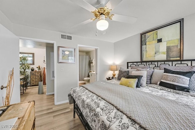 bedroom featuring ceiling fan, light hardwood / wood-style floors, and ensuite bath