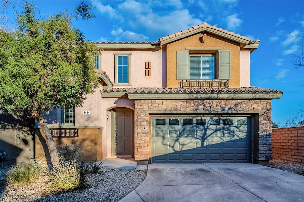 mediterranean / spanish-style home with a garage