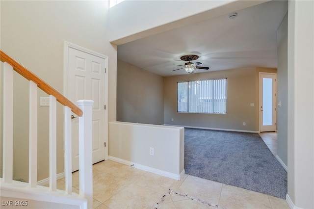 tiled empty room featuring ceiling fan and a wealth of natural light