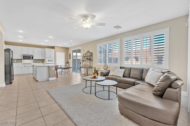 living room with ceiling fan and light tile patterned floors