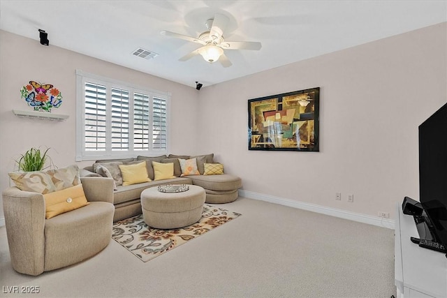 carpeted living room with ceiling fan