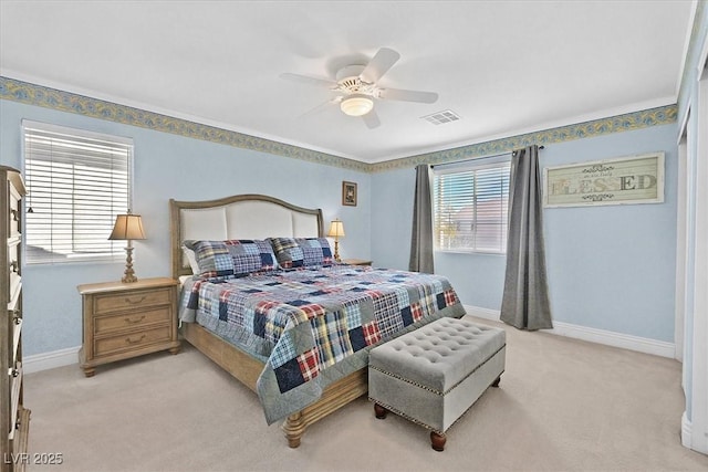 bedroom with ceiling fan and light carpet