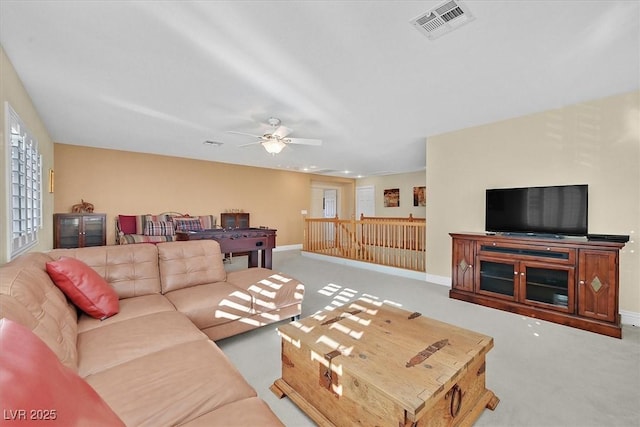 carpeted living room featuring ceiling fan