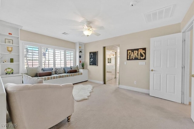 carpeted living room featuring ceiling fan