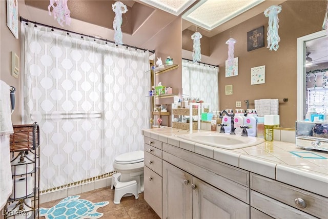 bathroom featuring tile patterned flooring, vanity, and toilet