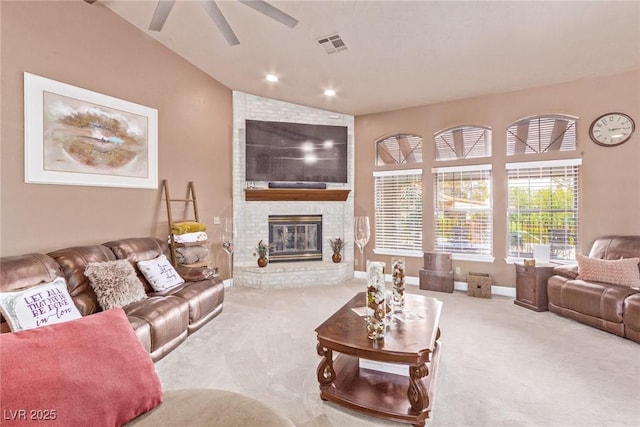 carpeted living room featuring ceiling fan, lofted ceiling, and a brick fireplace