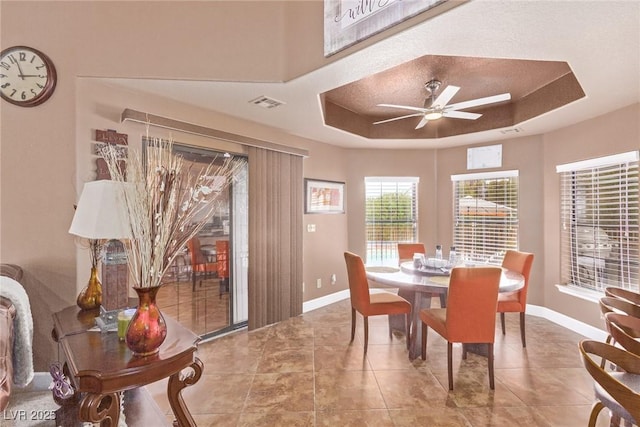 dining room featuring a tray ceiling and ceiling fan