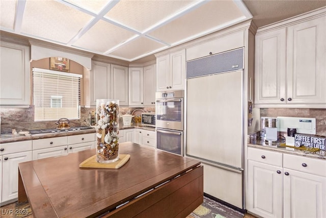 kitchen featuring white cabinetry and appliances with stainless steel finishes