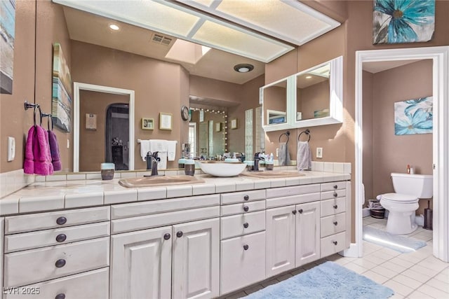 bathroom with tile patterned floors, vanity, and toilet