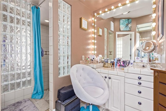 bathroom with a shower with curtain and vanity