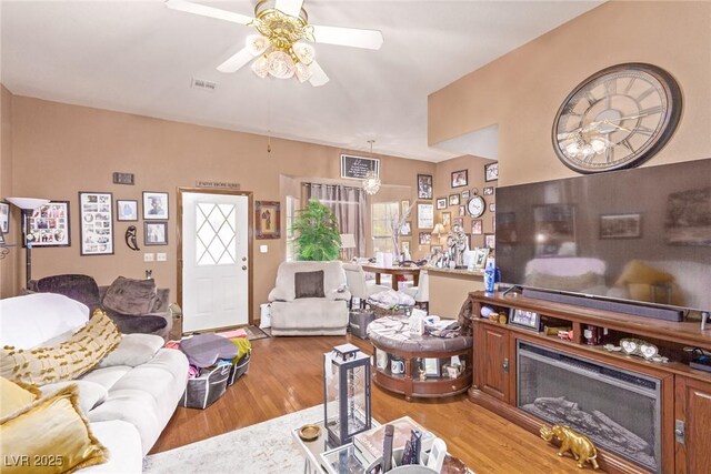 living room featuring ceiling fan and light hardwood / wood-style flooring