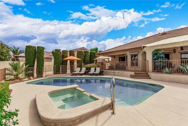 view of swimming pool with an in ground hot tub and a patio