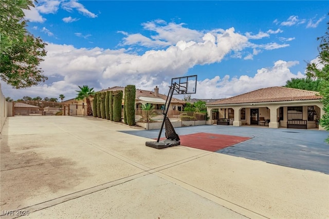 view of basketball court with fence