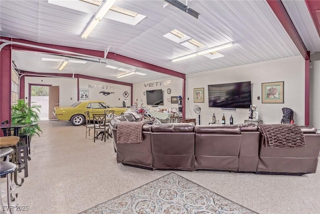 living area featuring a garage and speckled floor