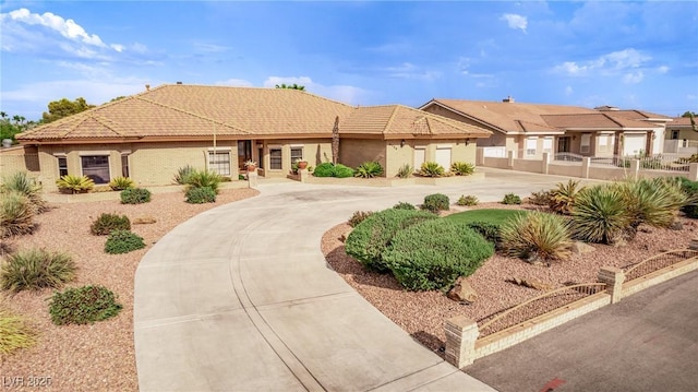 view of front of house featuring a tile roof and driveway