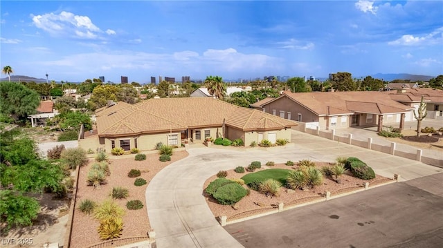 mediterranean / spanish house with a tile roof, driveway, and stucco siding