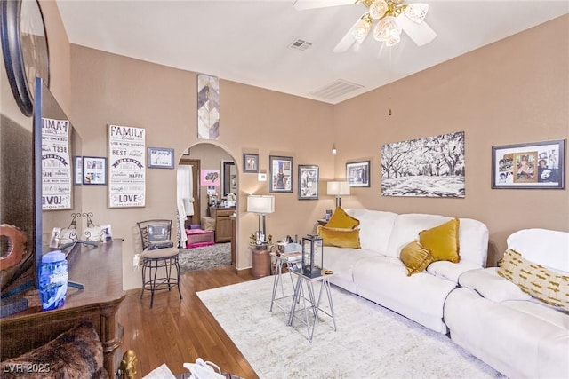 living room featuring wood-type flooring and ceiling fan