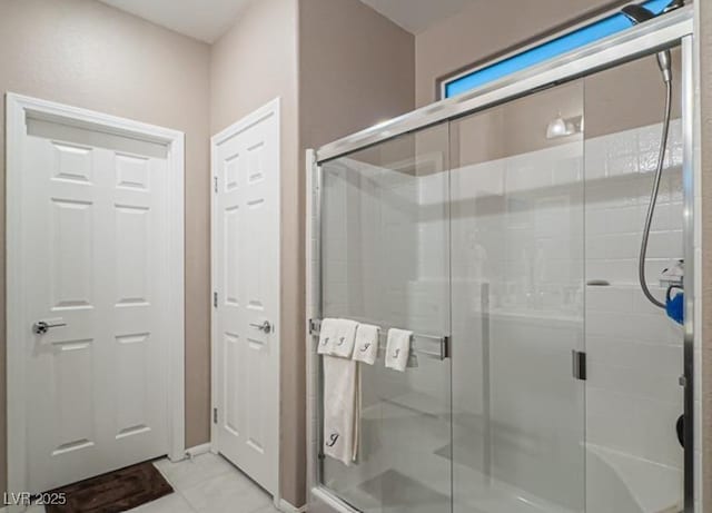 bathroom with walk in shower and tile patterned flooring