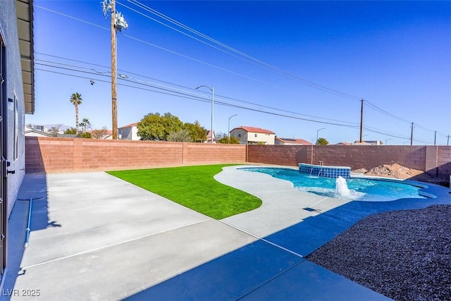 view of swimming pool with pool water feature and a patio area